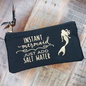 Fun !!! Black pouch with gold metallic writing.